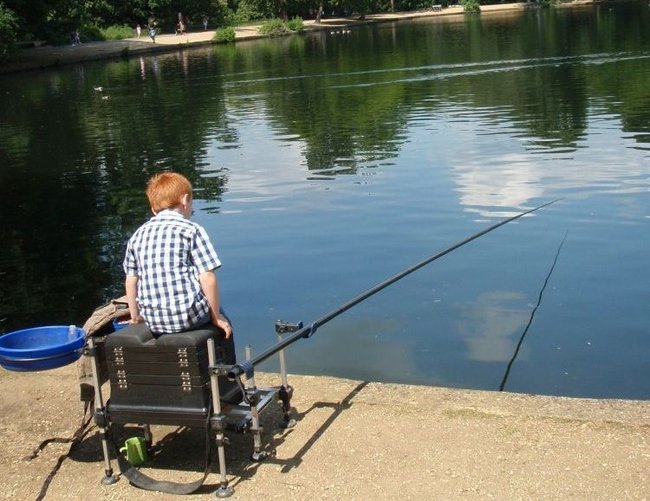 A child fishing on Black Park Lake