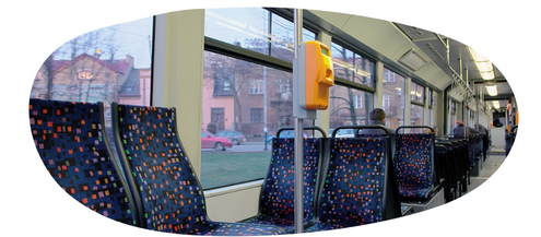 Image of the inside of a bus showing empty seats and the bus windows