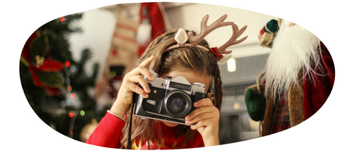 Person in a christmas outfit taking a photograph.