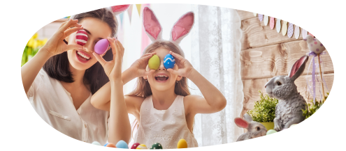 Parent and child wearing bunny ears holding easter eggs to their eyes and smiling.