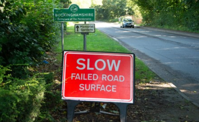 Slow - failed road surface sign