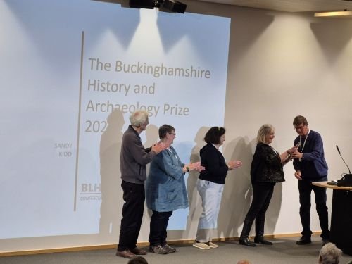 Local Heritage List team members standing on stage collecting the award.