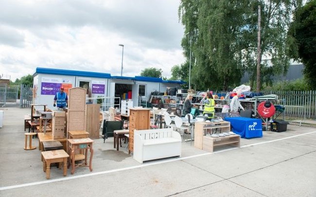Image of Reuse Shop with lots of furniture displayed outside of it