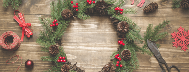 Festive wreath surrounded by pine cones and ribbon decorations